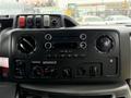 Dashboard of a 2017 Ford E450 featuring audio controls air conditioning dials and various buttons