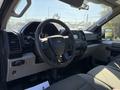 Interior view of a 2018 Ford F-150 showing the steering wheel dashboard controls and seats