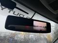 Rearview mirror display of a 2015 Ford F-450 showing a backup camera feed with guidelines on the screen