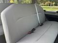 A gray bench seat from a 2013 Ford E-350 Super Duty with seat belts visible