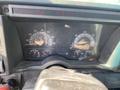 The dashboard of a 1996 GMC Top Kick displaying speedometer tachometer fuel gauge and various warning lights