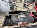 A 2005 Katolight SED60FPJ4 generator featuring a visible battery with labels and connected wires atop a metal base