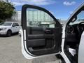 A 2019 Chevrolet Silverado 1500 with an open driver's side door showcasing the interior design and control panel
