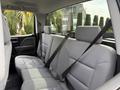 Interior view of a 2018 Chevrolet Silverado 1500 showcasing the rear seats with grey upholstery and seatbelts