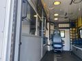 Interior view of a 2011 Chevrolet Express featuring a driver’s seat medical equipment storage and a partitioned area for passengers or patients