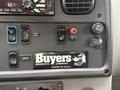 Dashboard controls of a 2019 Freightliner M2 featuring various switches knobs and a Buyers Products Company sticker