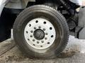 Close-up of a tire on a 2011 International WorkStar featuring a Michelin brand tire with distinct tread pattern and multiple lug nuts on the wheel rim