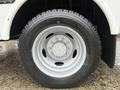 A close-up view of a 2015 Ford F-450 tire and rim showcasing a large black tire with a silver wheel hub
