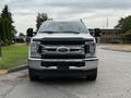 A 2019 Ford F-350 SD pickup truck is parked facing forward with a shiny chrome grille and black accents on the front bumper and mirrors