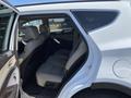 A 2018 Hyundai Santa Fe with its back door open revealing the spacious rear seating area and light-colored upholstery