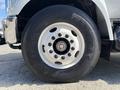 Close-up of a 2016 Ford F-750 tire and wheel showing a white rim with multiple lug nuts and Goodyear branding on the tire sidewall