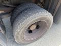 Close-up of a 2016 RAM 5500 truck tire showing rugged tread pattern and rust on wheel rim