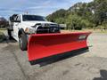 A 2013 RAM 5500 truck with a large red snow plow attached to the front