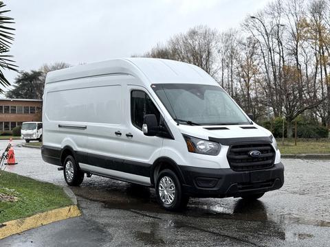A 2020 Ford Transit van with a white exterior and black lower trim facing slightly to the right