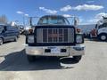 Front view of a 1996 GMC Top Kick truck featuring a black exterior chrome grille and orange marker lights on the roof