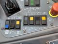 Control panel of a 2018 Sandvik Ranger DX800 featuring various buttons and switches in blue yellow and black colors along with indicator lights for different functions
