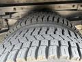 Close-up of a worn tire with deep treads on a 2018 Ford Econoline