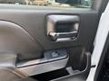 The interior door handle of a 2017 Chevrolet Silverado 1500 featuring a sleek design and control buttons