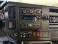 Dashboard of a 2019 Chevrolet Express featuring control knobs a digital display and multiple buttons for various functions
