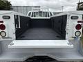 The image shows the open bed of a 2013 Ford F-250 SD with a diamond plate floor and side toolboxes installed
