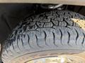 Close-up of the tire tread on a 2022 GMC Sierra 1500 showcasing deep grooves and rugged texture designed for off-road performance