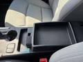 The image shows the center console of a 2015 Hyundai Sonata featuring a black storage tray with a textured surface and controls for the windows