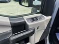 Interior door panel of a 2017 Ford F-550 featuring window controls and a handle