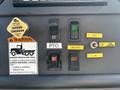 Control panel of a 2006 Freightliner M2 106 featuring various switches including parking brake warning PTO control bin light and bin heater settings