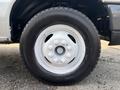 A close-up of the wheel of a 2008 Ford Econoline showing a white rim with six bolt holes and a black tire with visible tread pattern
