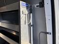 A close-up view of a metal shelving unit inside a 2024 Mercedes-Benz Sprinter 2500 with a steel hook and support bracket for securing items