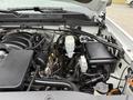 Close-up of the engine compartment of a 2016 GMC Sierra 1500 showing various components including the engine block battery and fluid reservoir