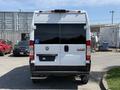 Rear view of a 2021 RAM Promaster van with a blacked-out rear window and a blue handicap parking permit sticker on the back door