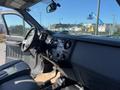 Interior view of a 2016 Ford F-250 SD showcasing the dashboard and controls with seats visible in the foreground