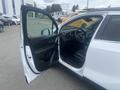 A 2018 Buick Encore with an open driver's side door revealing the interior features and dashboard