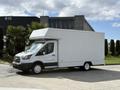 A 2016 Ford Transit van with a white box cargo area parked at an angle with its side facing the viewer