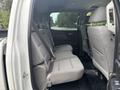 The interior of a 2016 GMC Sierra 1500 showing the rear seating area with gray fabric seats arranged in a row