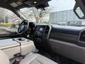 Interior of a 2020 Ford F-550 featuring a dashboard with controls a touchscreen display and seating arrangements with a central console
