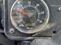 A gauge displaying RPM with a needle pointing to 15 and a digital hour meter reading 8264 on a black dashboard of a 2011 Autocar Xpeditor