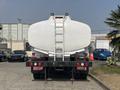 A 2010 Freightliner M2 106 truck with a large white tank attached to its rear and a ladder for access on top