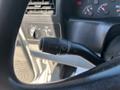 Close-up view of a 2004 Ford F-750 windshield wiper control lever with a textured grip and indicator markings