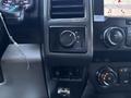 Interior dashboard controls of a 2019 Ford F-550 featuring knobs for drive modes and audio settings