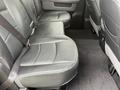 Rear seating area of a 2018 RAM 1500 with two bench seats featuring black leather upholstery and seatbelts