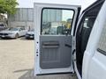 A 2011 Ford F-350 SD door is open showing the gray interior door panel and handle