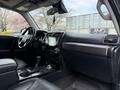 Interior view of a 2021 Toyota 4Runner featuring black leather seats a central console with a touchscreen display and various controls