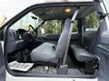 Interior of a 2001 Ford F-350 showing the front and rear seats with gray upholstery and a steering wheel visible