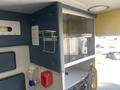 A 2011 Chevrolet Express interior view showing storage cabinets and medical equipment compartments with a focus on organized space for supplies and equipment