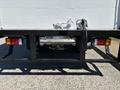 A 2022 Isuzu NQR truck with a visible rear bumper and trailer hitch system featuring two brake lights and a license plate holder