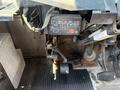 A 2012 Ford Econoline dashboard with a black control module and a foot pedal assembly visible in the foreground