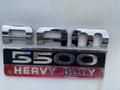 Chrome emblem of a 2011 Dodge Ram 5500 displaying the text RAM 5500 HEAVY DUTY