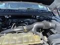 Engine compartment of a 2019 Ford F-150 showing the engine block air intake and coolant reservoir